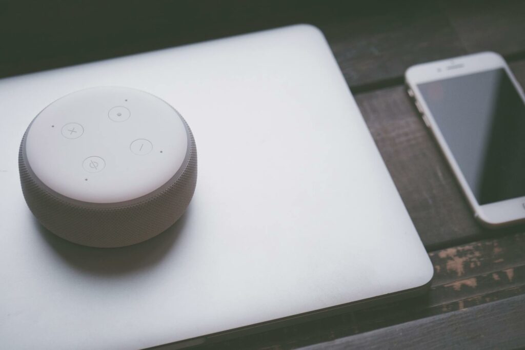 White Bluetooth Speaker On Silver Laptop Computer